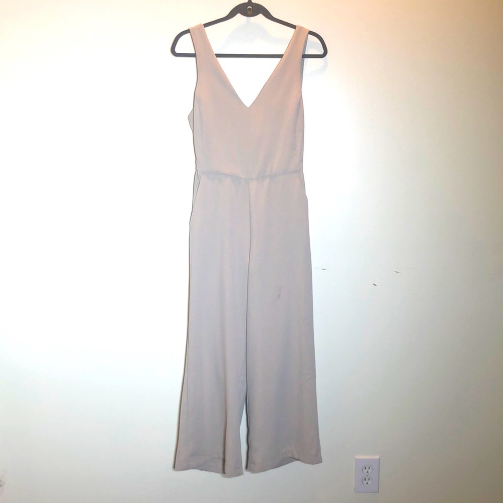 Beautiful Beige jumper with pockets and back out. New with tags.